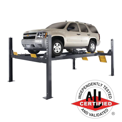 Beige Chevrolet Tahoe SUV lifted on a four-post automotive lift with ALI Certified badge