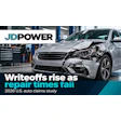 Damaged silver sedan in auto repair shop with JD Power headline about rising writeoffs and falling repair times