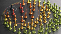 Colorful game pieces arranged in concentric circles with connecting lines representing organizational hierarchy or network structure