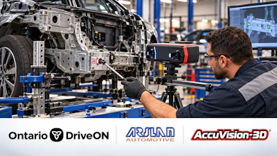 Technician using 3D scanning camera to inspect vehicle frame in automotive manufacturing facility