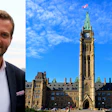 Professional man in business attire beside Parliament of Canada's Centre Block under blue sky