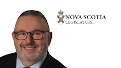 Professional headshot of a man wearing glasses and dark suit with Nova Scotia Legislature logo