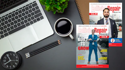 Collision Repair Magazine cover displayed on desk with laptop, coffee, and office supplies