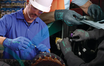 Industrial workers wearing blue AppFlex safety gloves assembling or inspecting automotive components on a production line