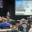 Professional speaker presenting 'The Leadership Shift' at SEMA education conference with audience seated at tables.