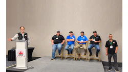 Panel discussion at ARC conference with speaker at podium and five seated panelists