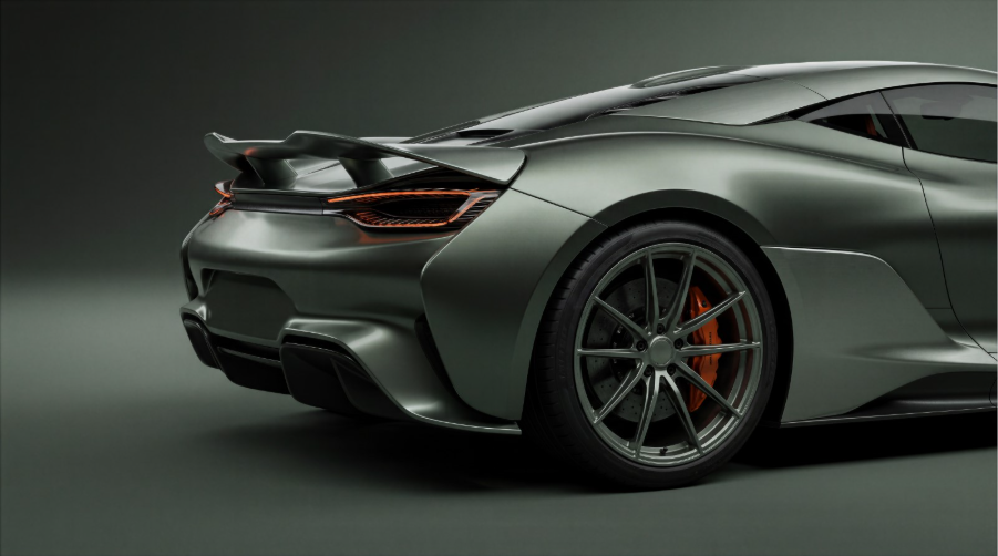 Silver high-performance sports car with red brake calipers and aerodynamic design photographed against neutral background