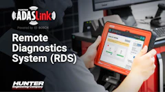 Technician holding Hunter ADAS Link diagnostic device powered by Bosch for remote vehicle diagnostics