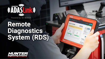 Technician holding Hunter ADAS Link diagnostic device powered by Bosch for remote vehicle diagnostics