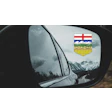 Alberta provincial shield reflected in car side mirror with snowy mountain landscape