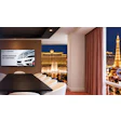Modern conference room with Plasnomic logo on screen overlooking Las Vegas Strip at night