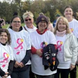 Group of women wearing pink ribbon t-shirts at outdoor breast cancer awareness event