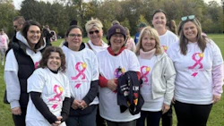Group of women wearing pink ribbon t-shirts at outdoor breast cancer awareness event