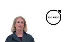Professional woman in dark blazer with Volvo logo featuring circular design and upward arrow