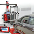 Professional wheel alignment service with Hunter Bosch equipment and technician working on gray vehicle